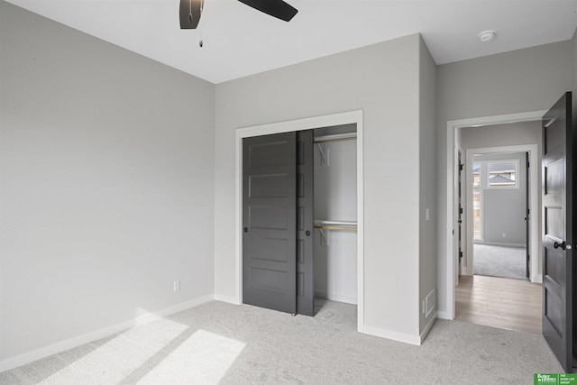 unfurnished bedroom featuring ceiling fan, carpet floors, a closet, and baseboards