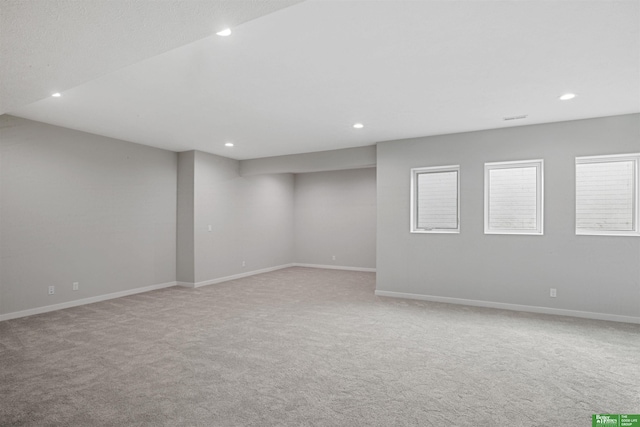 empty room featuring baseboards and recessed lighting