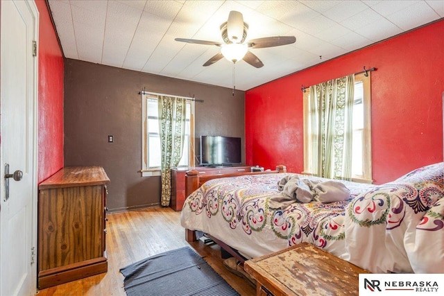 bedroom with ceiling fan and wood finished floors