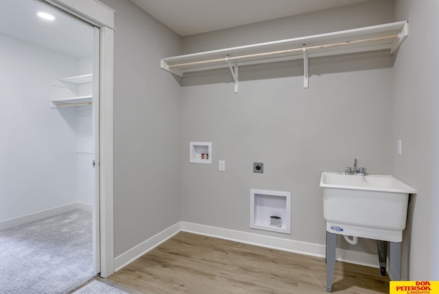 3563 Little Bluestem Rd, Fremont, NE 68025 - laundry area featuring hookup for an electric dryer, hookup for a washing machine, and light wood-style flooring