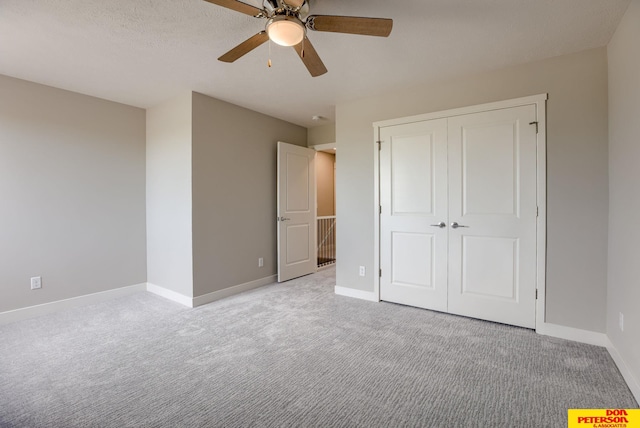 3563 Little Bluestem Rd, Fremont, NE 68025 - unfurnished bedroom featuring light carpet, a closet, and ceiling fan