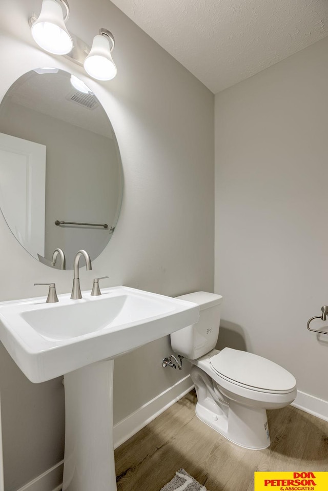 3563 Little Bluestem Rd, Fremont, NE 68025 - bathroom with wood finished floors and a textured ceiling
