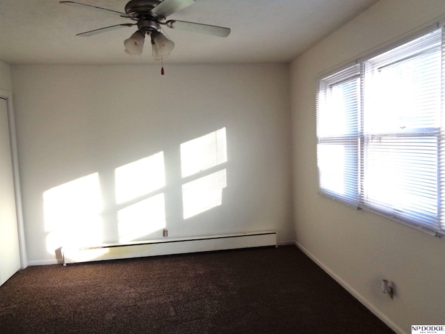 carpeted spare room with a baseboard heating unit, a ceiling fan, and baseboards