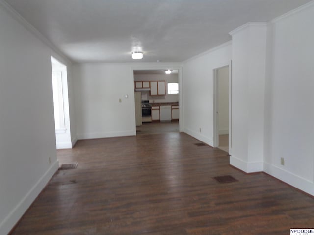 unfurnished living room with visible vents, baseboards, dark wood-style flooring, and ornamental molding