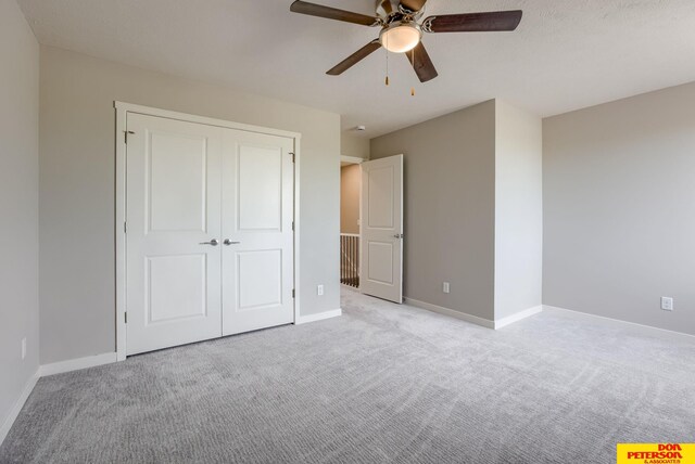 3575 Little Bluestem Rd, Fremont, NE 68025 - unfurnished bedroom with carpet flooring, a closet, and a ceiling fan