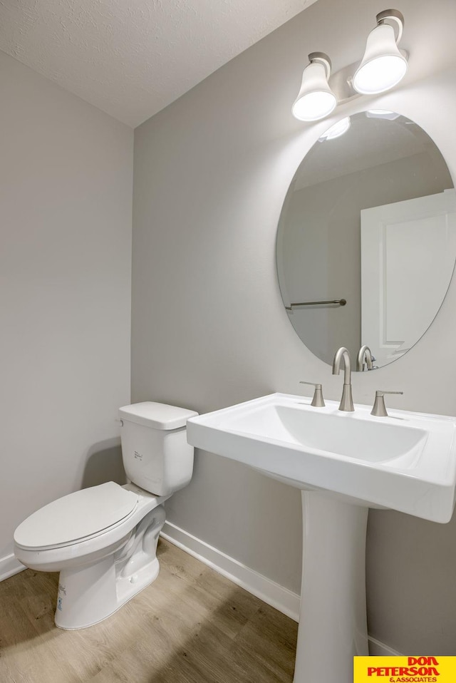3575 Little Bluestem Rd, Fremont, NE 68025 - bathroom with wood finished floors and a textured ceiling