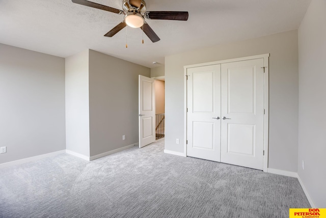 3587 Little Bluestem Rd, Fremont, NE 68025 - unfurnished bedroom featuring carpet, a closet, and ceiling fan