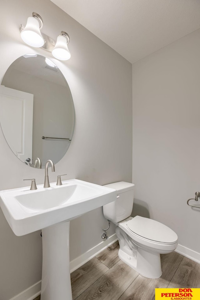 3587 Little Bluestem Rd, Fremont, NE 68025 - half bath with wood finished floors and toilet