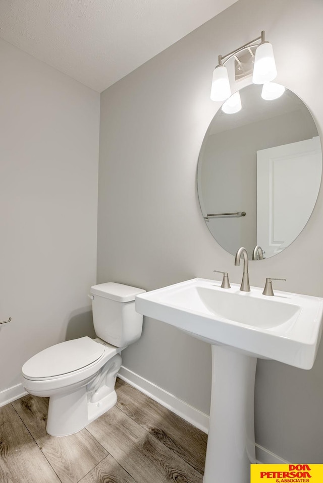 3593 Little Bluestem Rd, Fremont, NE 68025 - half bath featuring toilet and wood finished floors