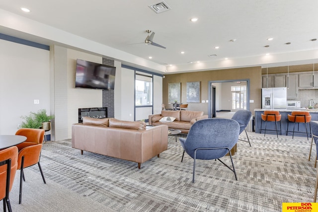 3593 Little Bluestem Rd, Fremont, NE 68025 - living room with a fireplace, a ceiling fan, recessed lighting, and light colored carpet