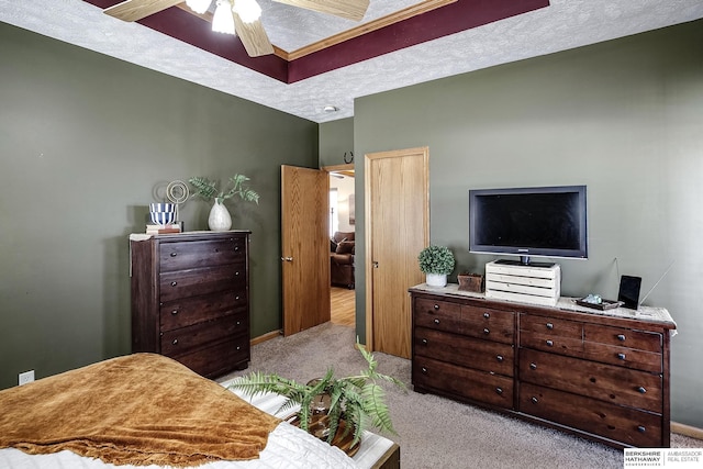 bedroom with a ceiling fan, a textured ceiling, and carpet flooring