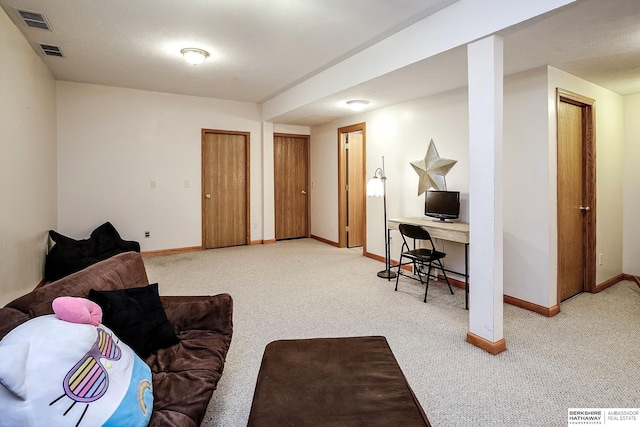 living area featuring visible vents, carpet, and baseboards