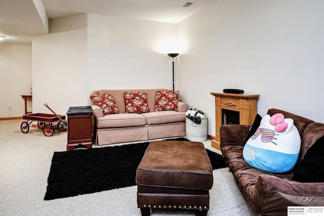 carpeted living room with a fireplace and baseboards