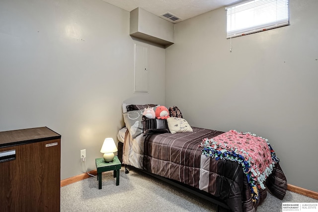 carpeted bedroom with visible vents and baseboards