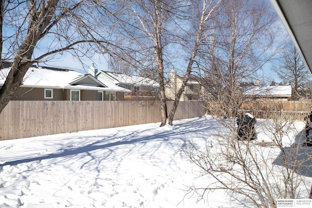 yard layered in snow with fence private yard