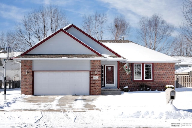 single story home with brick siding, an attached garage, and fence