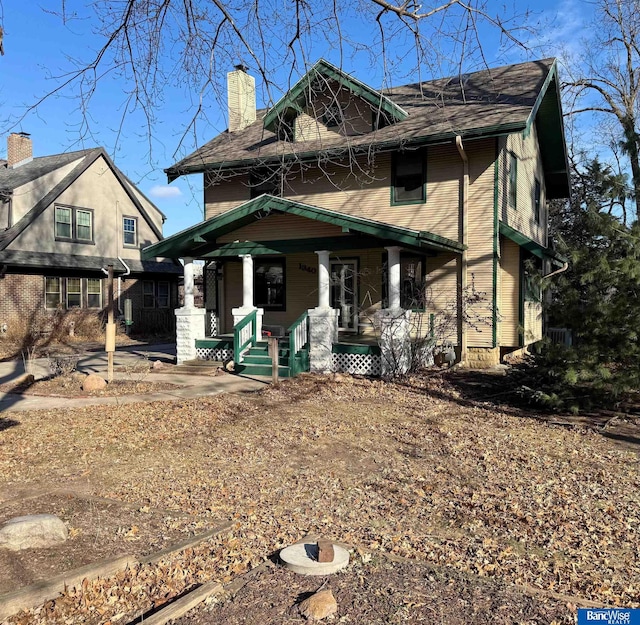 view of front of house featuring a porch and a chimney