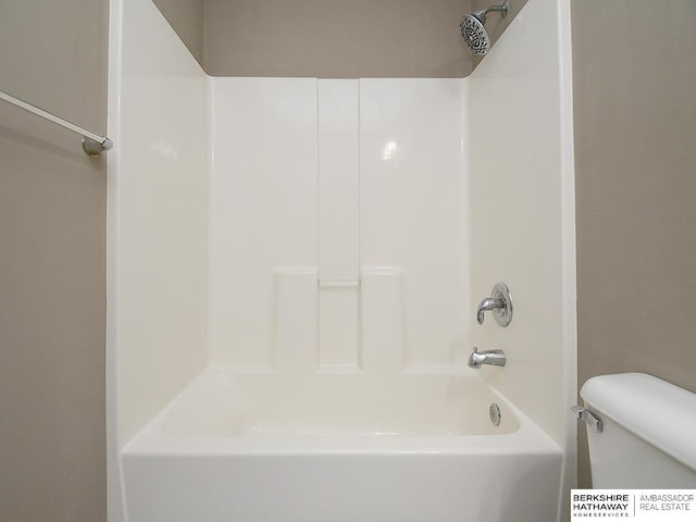 bathroom with shower / tub combination and toilet