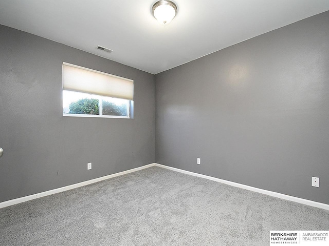 carpeted empty room with visible vents and baseboards