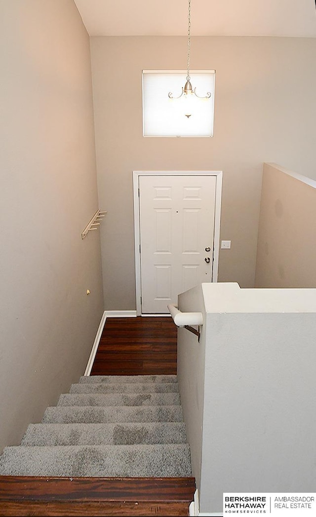 stairway with baseboards and wood finished floors