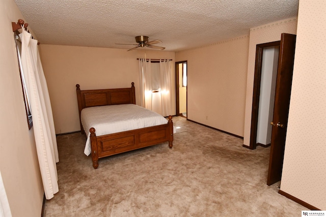 bedroom featuring light carpet, wallpapered walls, a ceiling fan, and a textured ceiling