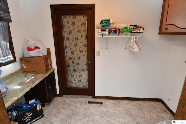 washroom featuring light colored carpet, visible vents, and baseboards