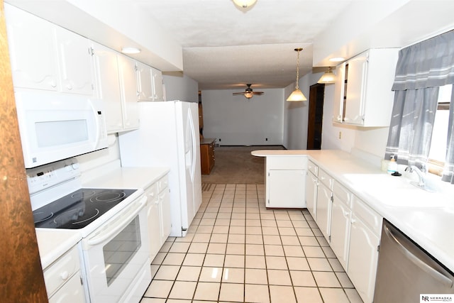 kitchen with light countertops, hanging light fixtures, white cabinets, a sink, and white appliances