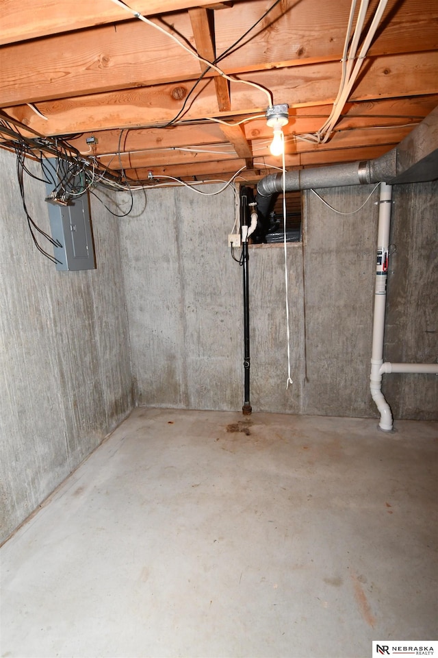 unfinished basement featuring electric panel