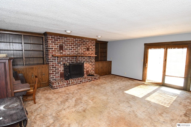 unfurnished living room featuring light colored carpet, a fireplace, a textured ceiling, and baseboards