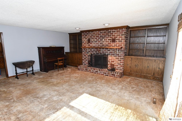 living area featuring light carpet, a fireplace, and a textured ceiling