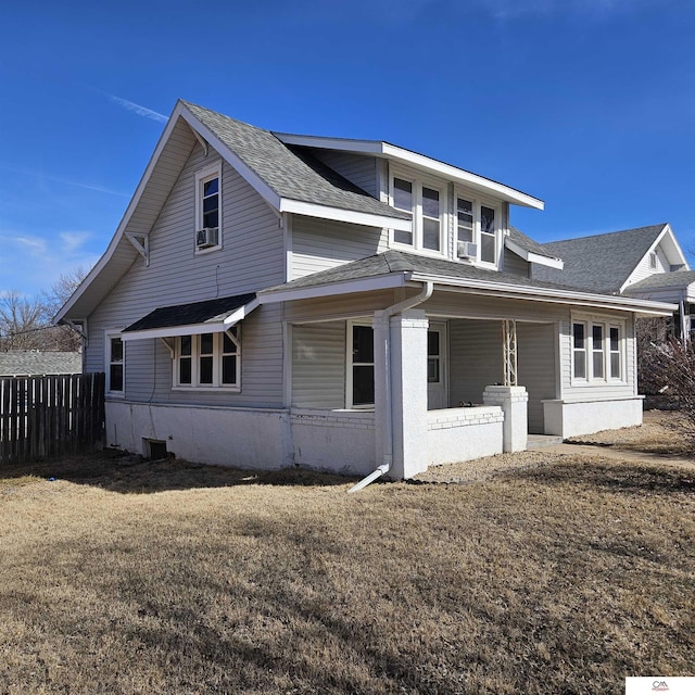 909 9th St, Fairbury, NE 68352 - view of home's exterior featuring a shingled roof, fence, and a lawn