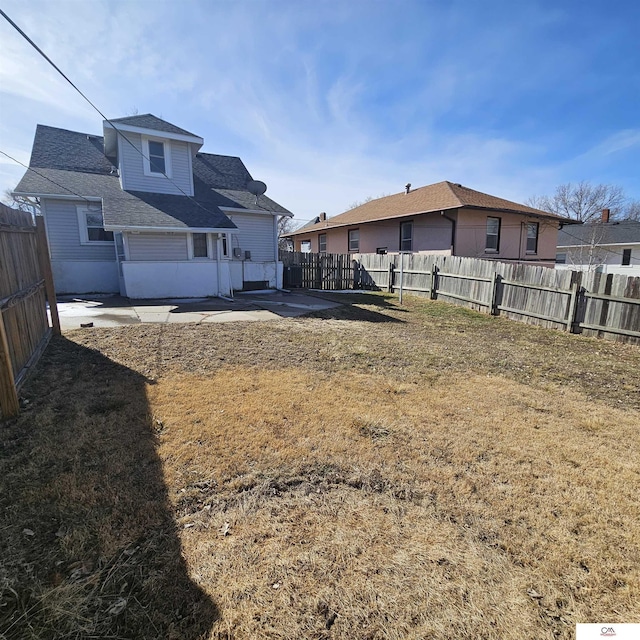 view of yard featuring a patio area and a fenced backyard