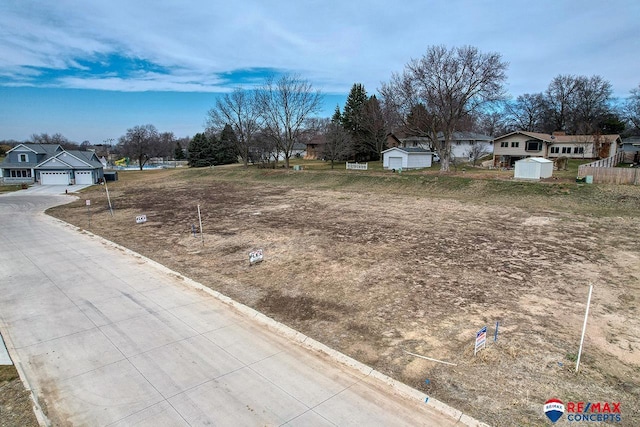 view of yard featuring a garage and a residential view