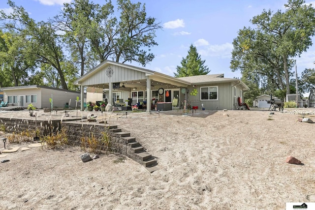 rear view of property featuring a patio area and board and batten siding