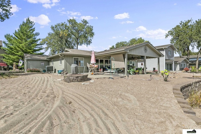 rear view of house featuring an attached carport, central AC, a patio, and ceiling fan