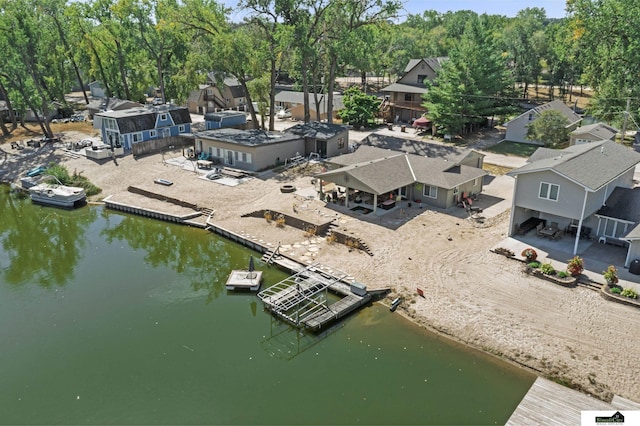 drone / aerial view with a water view and a residential view