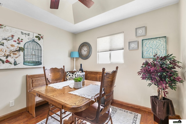 dining room with a ceiling fan, baseboards, and wood finished floors