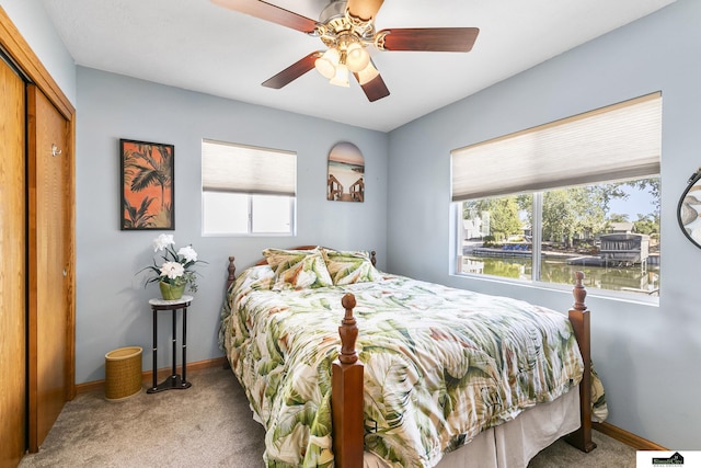 bedroom featuring carpet floors, baseboards, and a ceiling fan