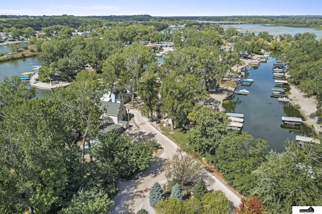 aerial view featuring a water view and a wooded view