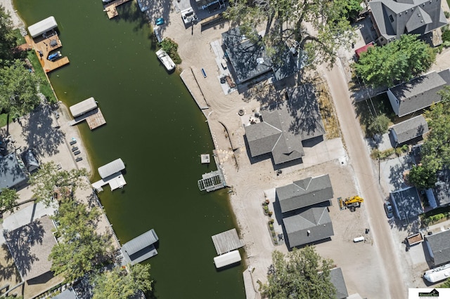 birds eye view of property with a water view and a residential view