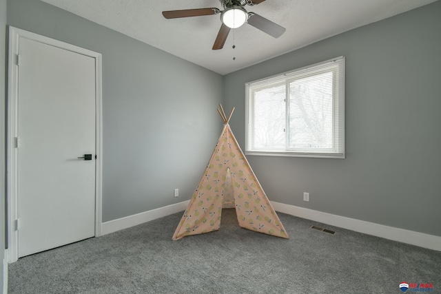 playroom featuring carpet, visible vents, ceiling fan, and baseboards