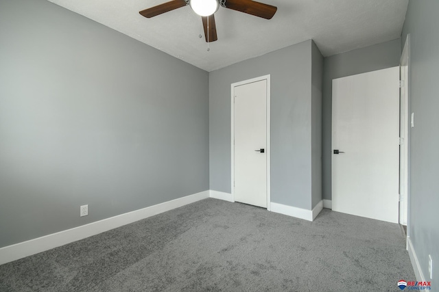 unfurnished bedroom with carpet floors, baseboards, and a ceiling fan