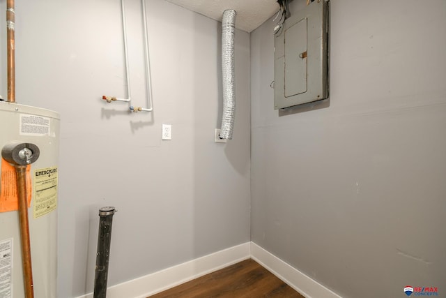 laundry room with water heater, dark wood-style flooring, electric panel, and baseboards