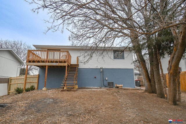 rear view of property featuring stairway, fence, a wooden deck, and central air condition unit