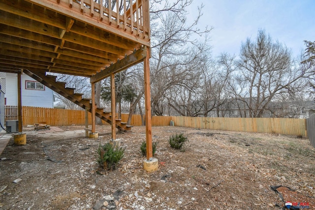 view of yard with a fenced backyard and central AC