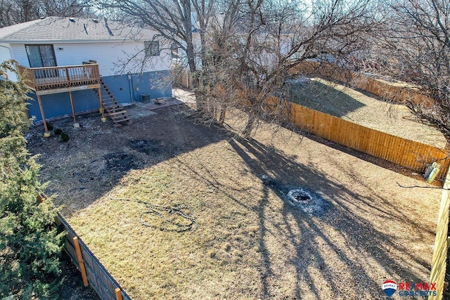 view of yard with stairway, a fenced backyard, and a wooden deck