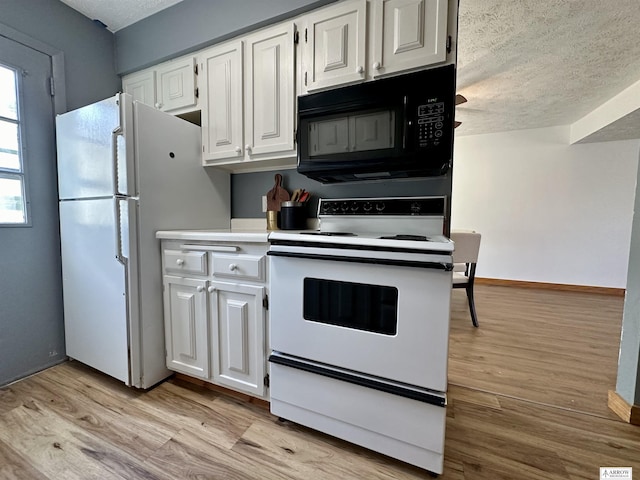 kitchen featuring light wood-type flooring, white appliances, white cabinets, and light countertops