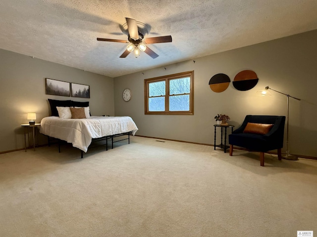 bedroom featuring ceiling fan, baseboards, a textured ceiling, and carpet flooring