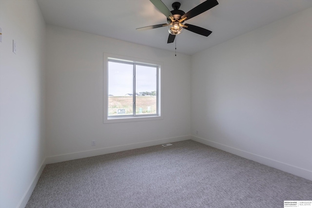 unfurnished room with carpet, visible vents, ceiling fan, and baseboards