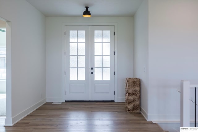 doorway featuring french doors, plenty of natural light, and wood finished floors